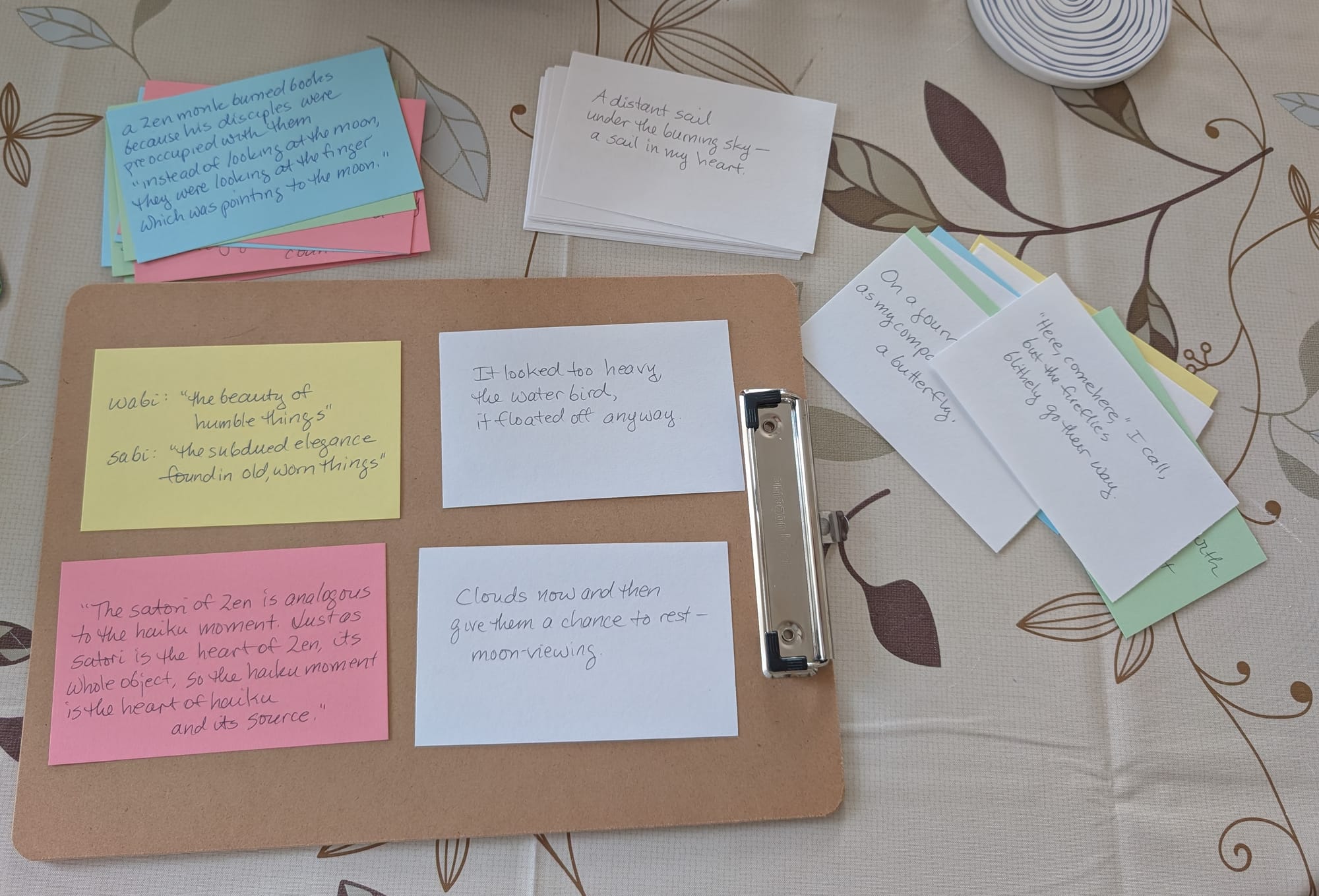 photo of 4 index cards on a wooden tray, plus stacks of index cards around the tray